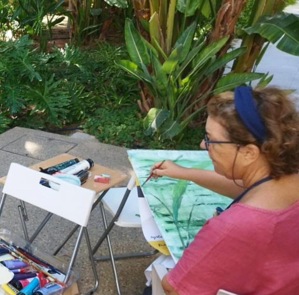 Monica painting outside